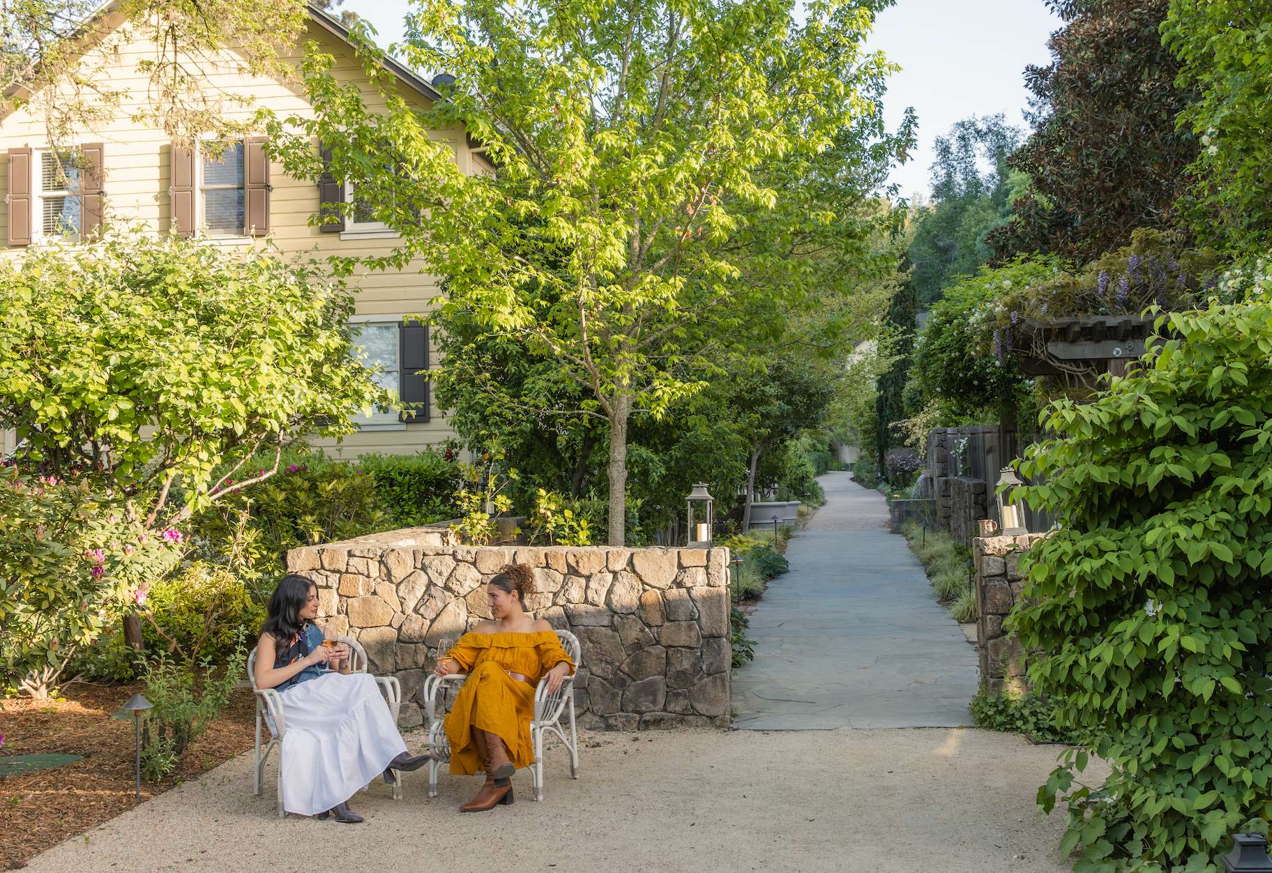 two women sitting on chairs outside