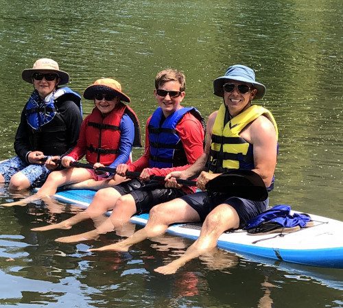 Joe and his sons sitting on a kayak