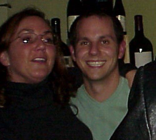 Joe and Catherine Bartolomei back in the day in front of wine bottles