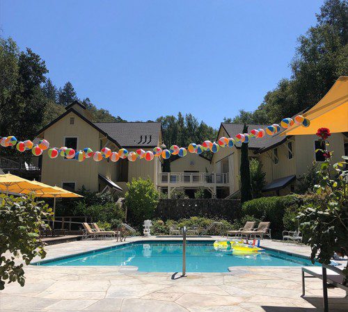 outside picture of pool with decorative beach balls