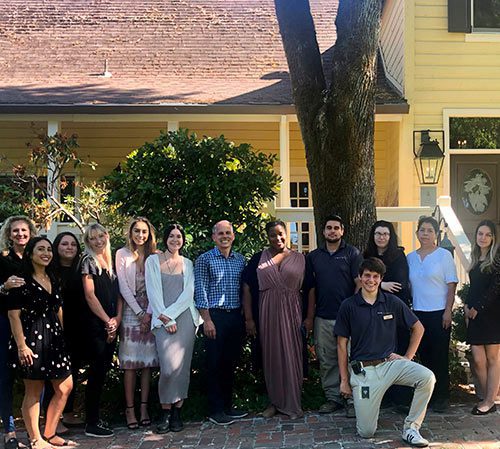 group photo of Farmhouse employees outside property