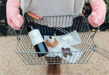 close-up photo of someone holding a metal basket wine and s'mores.