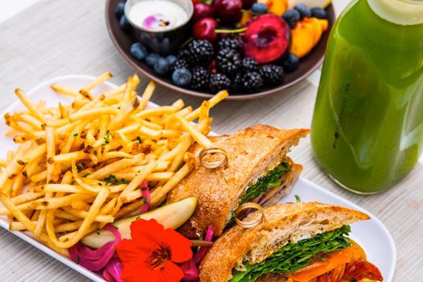 sandwich and fries, fruit plate and green juice