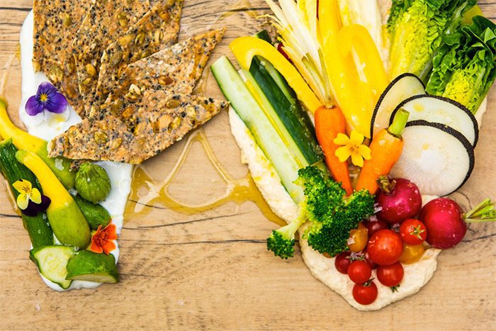 colorful vegetables with crackers and flower garnish