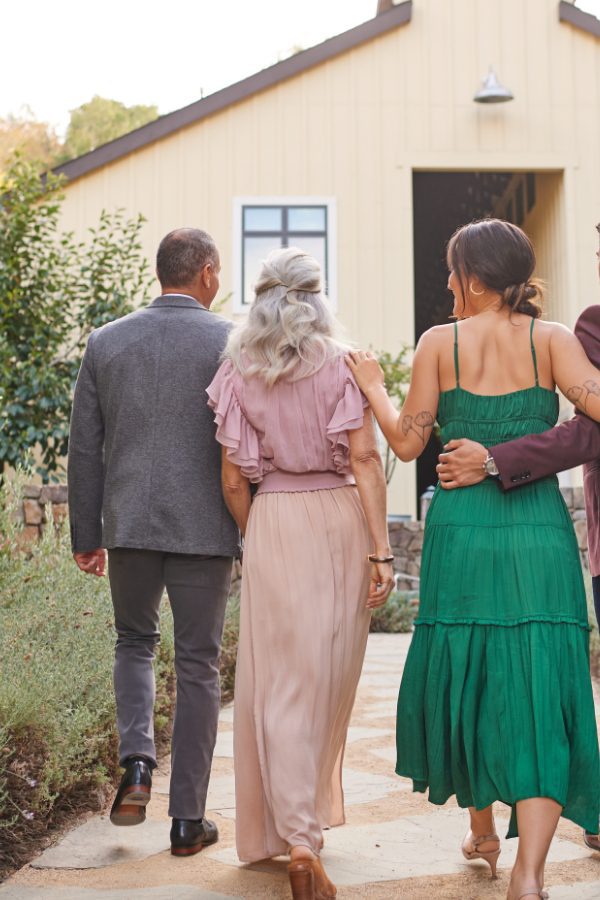 four Farmhouse inn guests walking together towards Barnroom building.