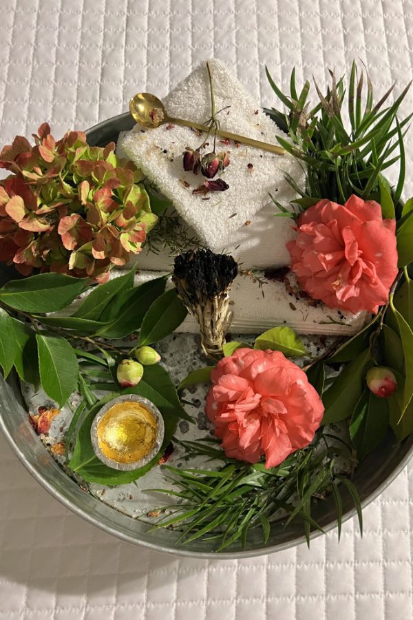 aerial shot of treatment tray with fresh flowers, sage, and treatments in Farmhouse Spa