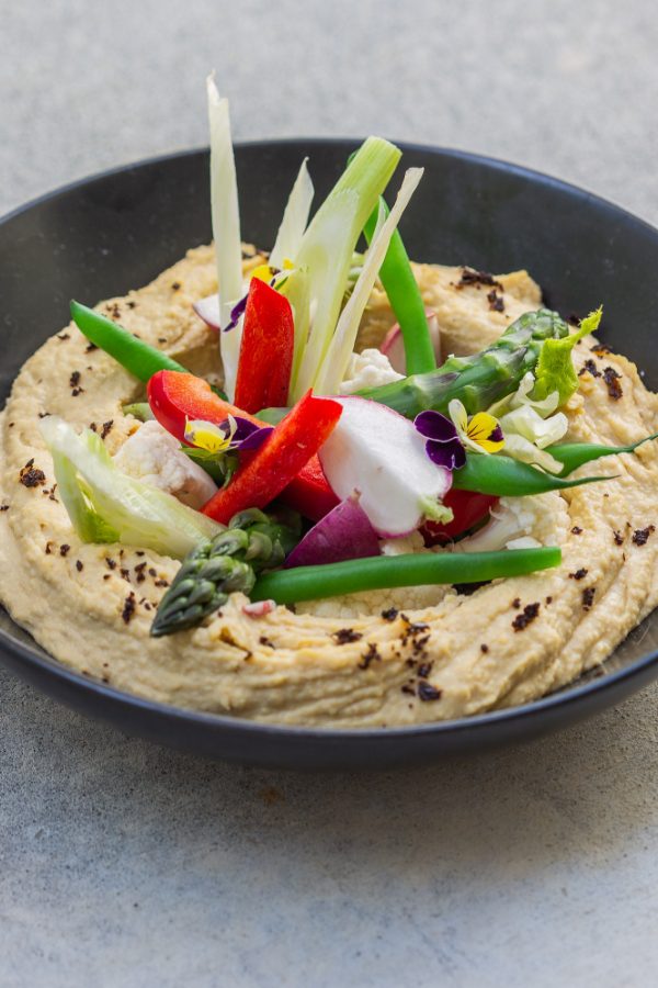 bowl of hummus with charred vegetables