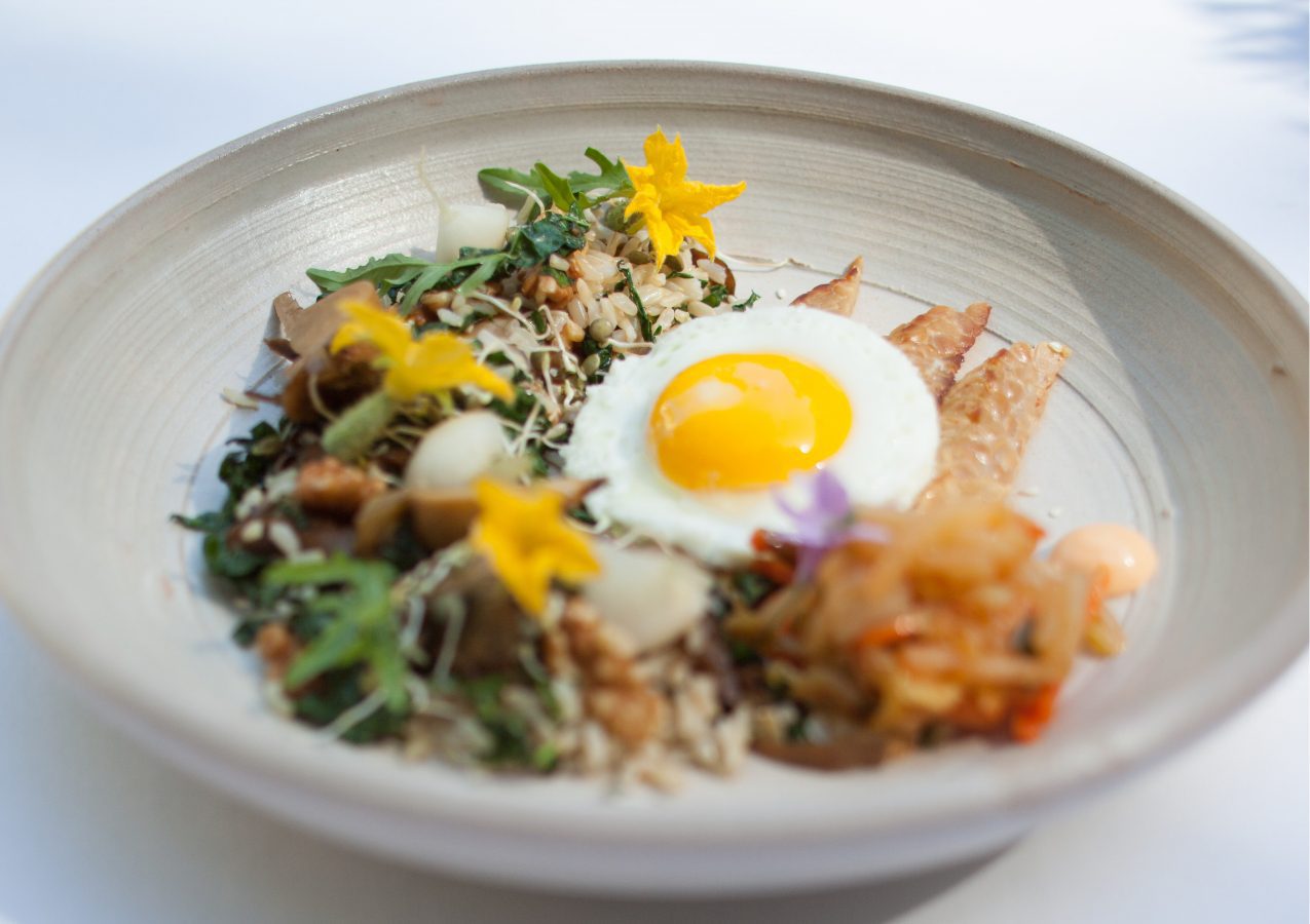 rice bowl with kimchi and egg, and flower garnishes