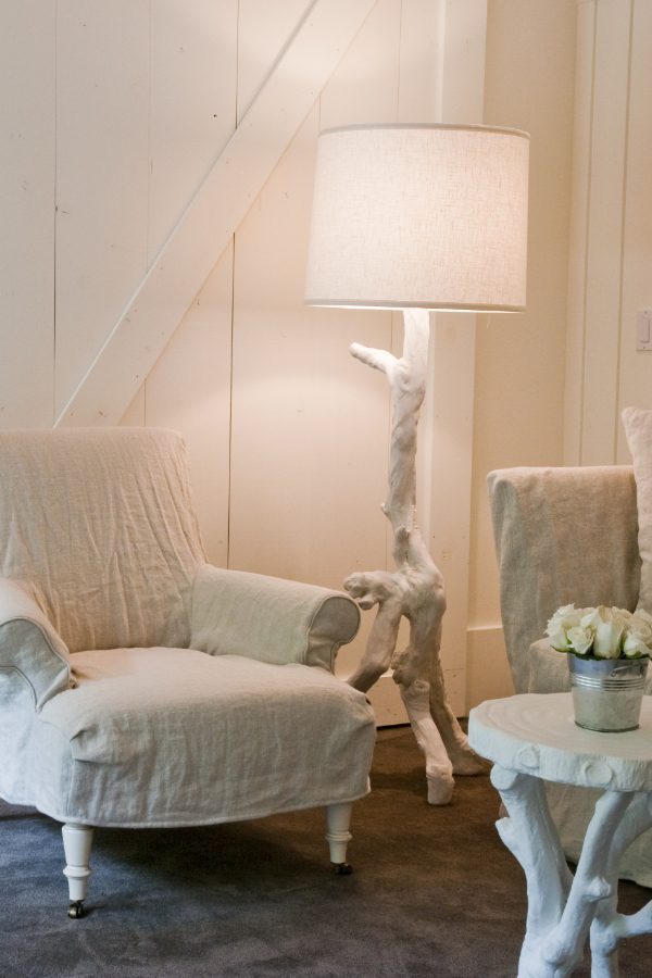 Interior of Barn One Bedroom Suite: Dark blue carpet, white cushioned chair and love seat.