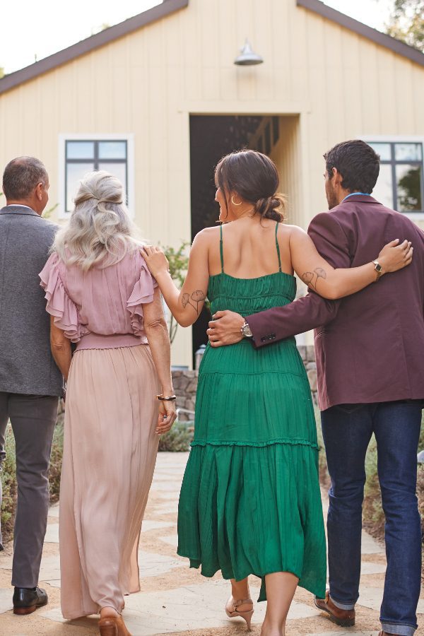 four Farmhouse inn guests walking together towards Barnroom building.