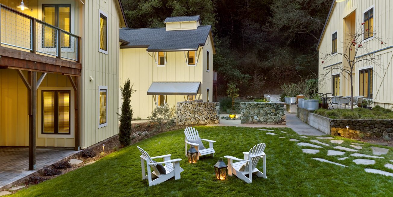 Farmhouse Inn outdoor seating area and patio near the barn room building at dusk