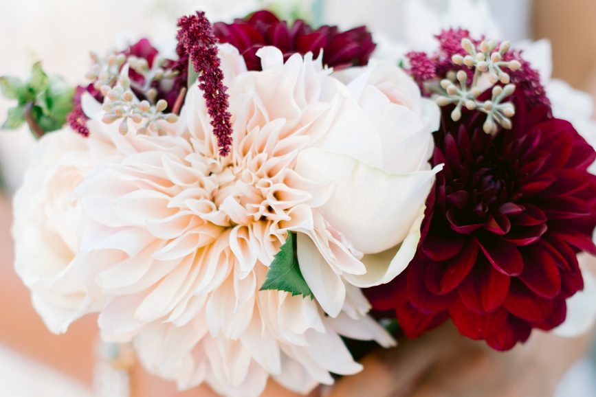 closeup shot of a wedding bouquet of pink and red flowers