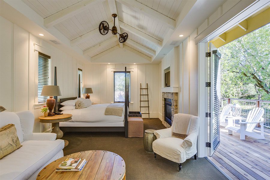 barnroom style hotel room, with a king size bed, seating area, and balcony