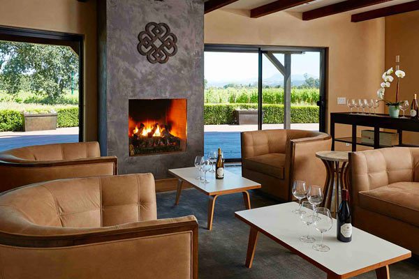 lobby / room with leather chairs and fireplace next to vineyard