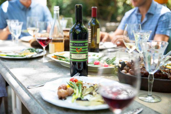 davero wine bottle on table with group eating