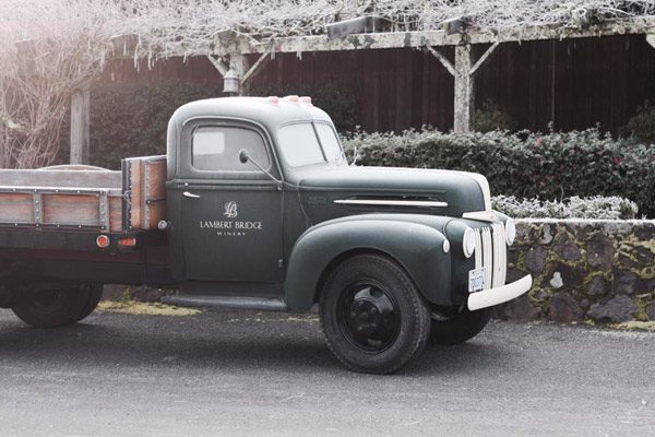 old school green truck with lambert bridge logo on the side