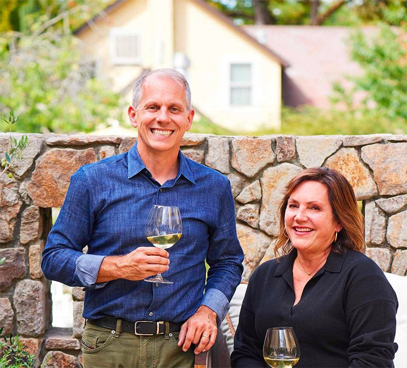 Joe and Catherine Bartolomei smiling on the Farmhouse Inn property