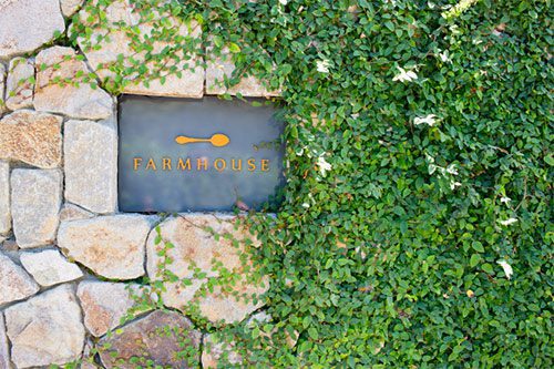 Farmhouse Inn sign in stone wall