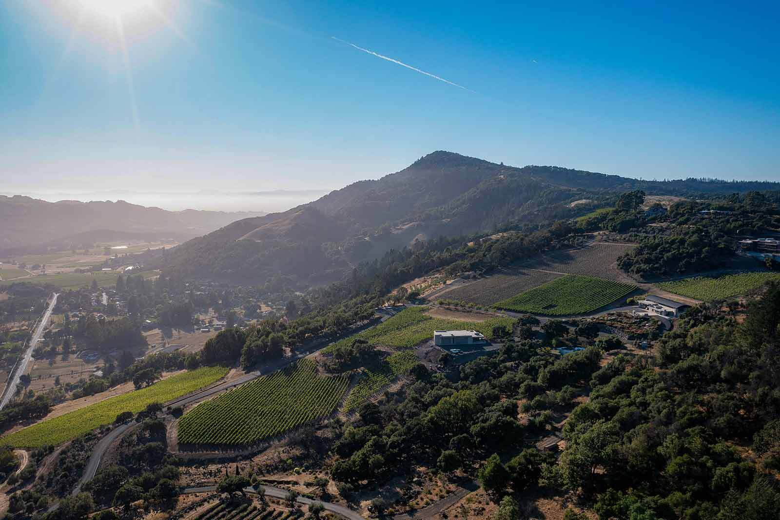 aerial rustic view of Sonoma County with large hill in background and greenery.