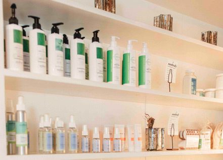Shelves of cosmetic products including lotions and sprays