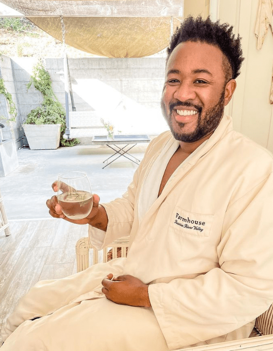 Man in Wellness Barn lobby with spa water